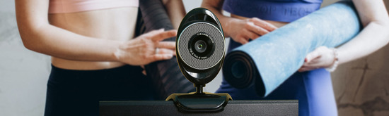 Two yoga students standing in front of a webcam