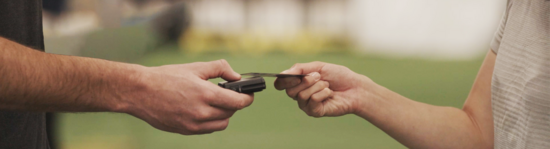 Photo of a client using a credit card to pay for a service