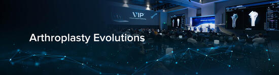 Photograph of three podium presenters in front of a large audience with the words "Arthroplasty Evolutions."