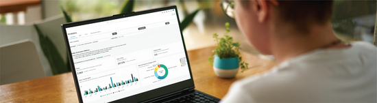 Person navigating their Analytics dashboard in Mindbody software